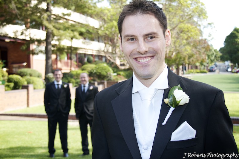 Groom with groomsmen behind him - wedding photography sydney